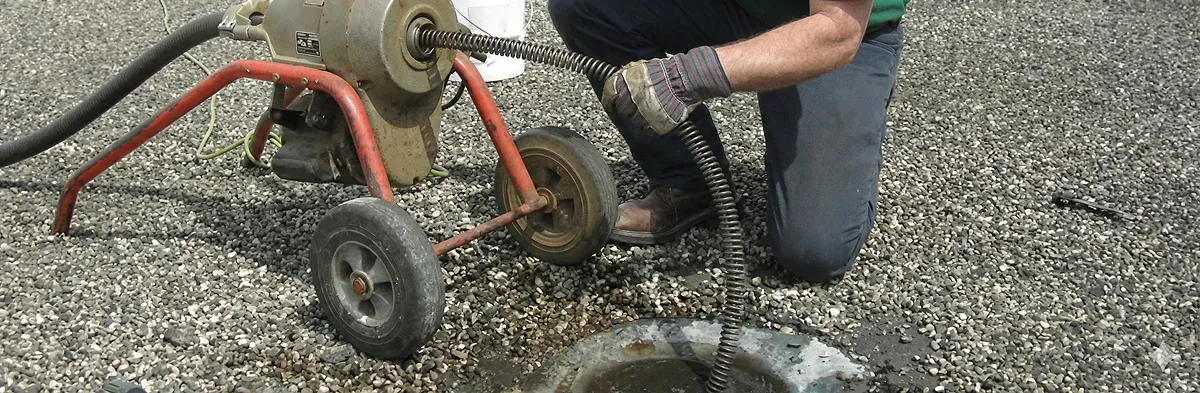sewer rodding technician actively removing blockages from a sewer line in Bloomington, IN